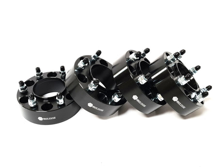 Close-up of black metal wheel hubs with bolts, reflecting aftermarket accessories for enhancing the individuality and appeal of pick-up trucks.