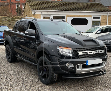 A black truck parked in a driveway, highlighting aftermarket accessories, showcasing Brute Status's customization expertise for individual, cool, and desirable pick-up trucks.