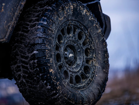 Close-up of a rugged tire with deep tread, suitable for customizing off-road vehicles, reflecting Brute Status's aftermarket accessory focus.