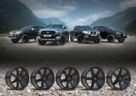 Hawke Wheels Summit in Matt Black, showcased with black rims on a rocky surface, emphasizing their robust design and fit for off-road vehicles.