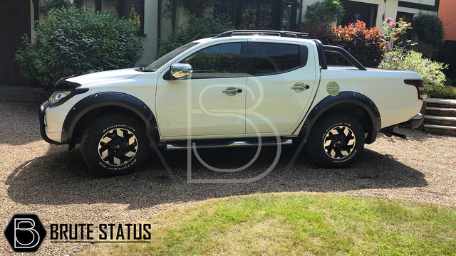 Mitsubishi L200 Series 5 2015-2019 Fender Flares showcased on a white truck, highlighting their robust, wide design and smooth black finish.