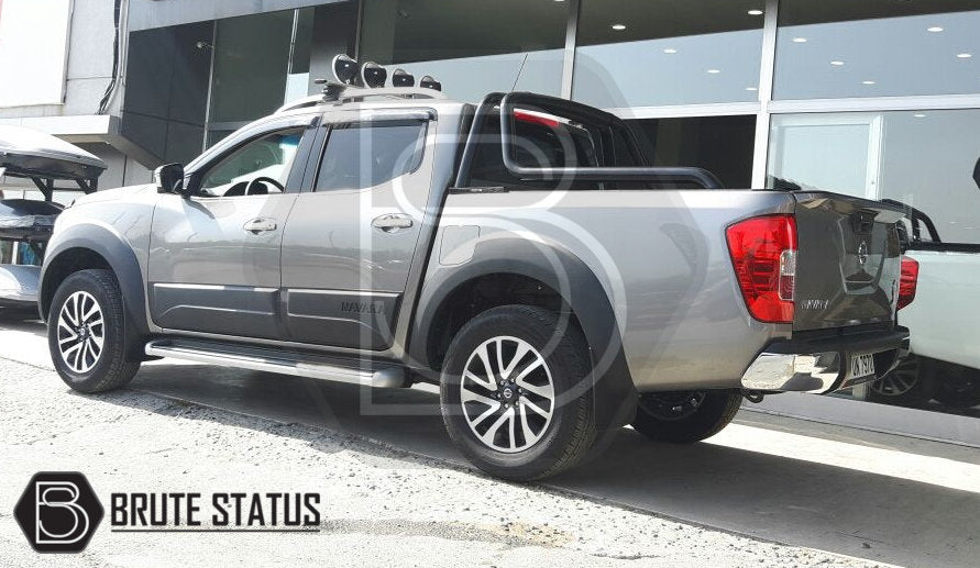 Nissan Navara NP300 2015-2022 Window Deflector Sun Shade on a grey truck, enhancing style and protection with durable, aerodynamic acrylic design.