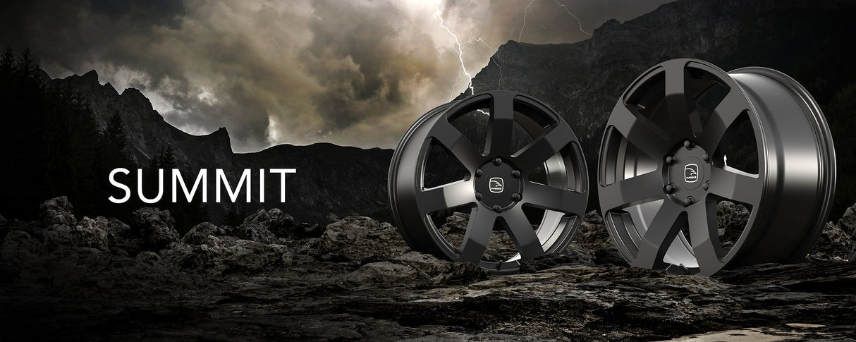 Hawke Wheels Summit in Matt Black, displayed on rocky terrain, highlighting its robust design and compatibility with various vehicle specifications.