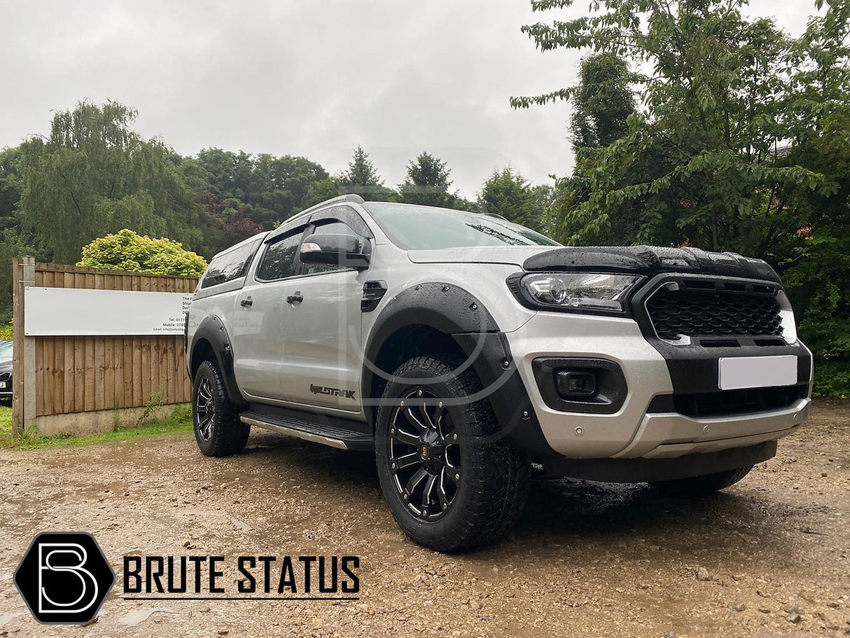 Ford Ranger 2019-2022 T8 Black/Silver Grille (Non-Wildtrak Only) displayed on a silver truck parked outdoors, highlighting the smooth black finish and silver accents.