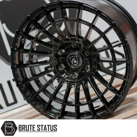 Spartan SW5 Wheels, black rim displayed on wood, ideal for enhancing pick-up truck aesthetics. Comes in 20x9.5 size with full fitting kit included.