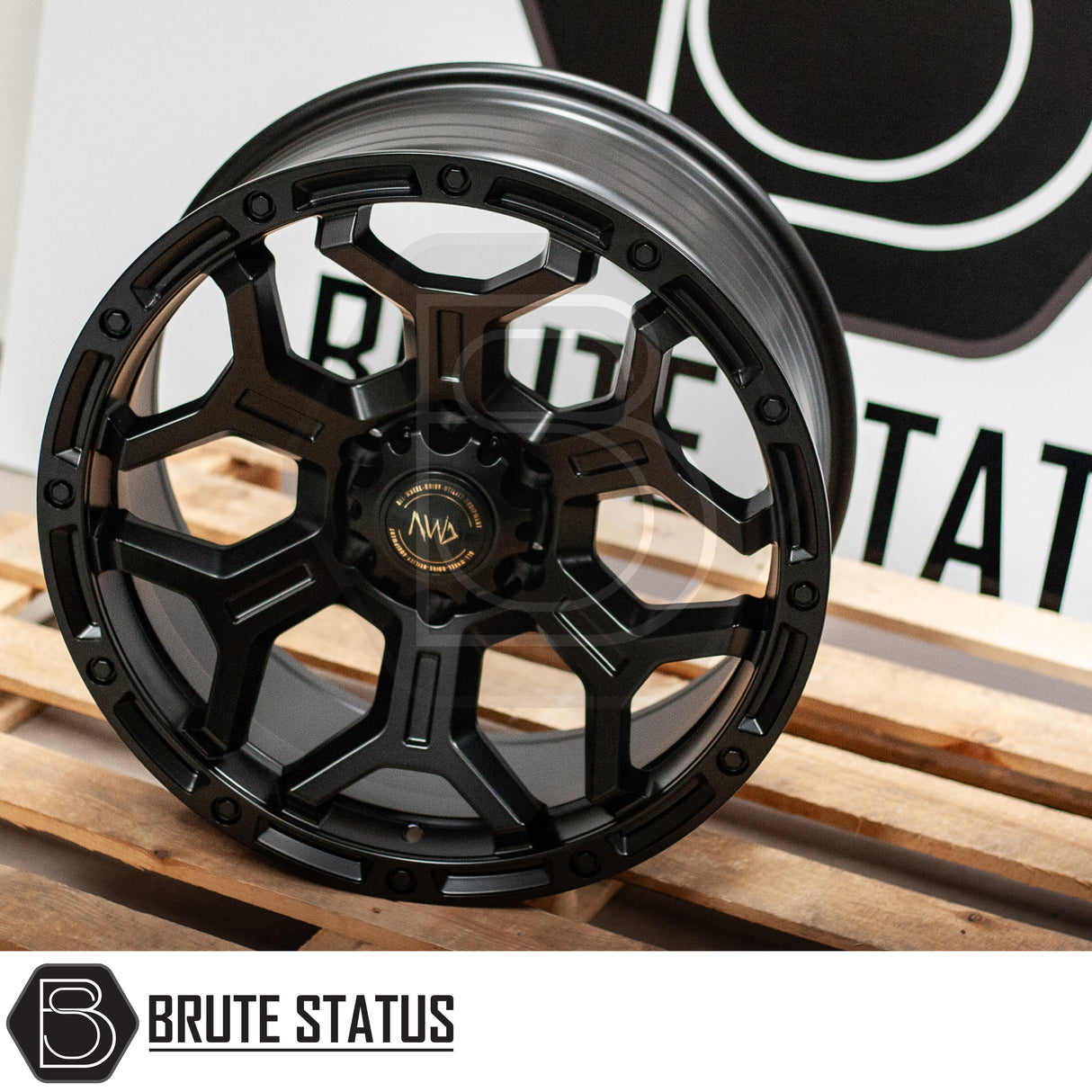 Hawke AWD Wheels Diablo in Matte Black, featuring a sleek black rim with a distinct gold logo, designed for enhanced pick-up truck customization.