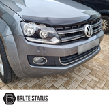 VW Amarok 2010-2016 Bonnet Guard Protector & Window Wind Deflectors, showcasing a close-up of the car's front, highlighting the durable, aerodynamic design.