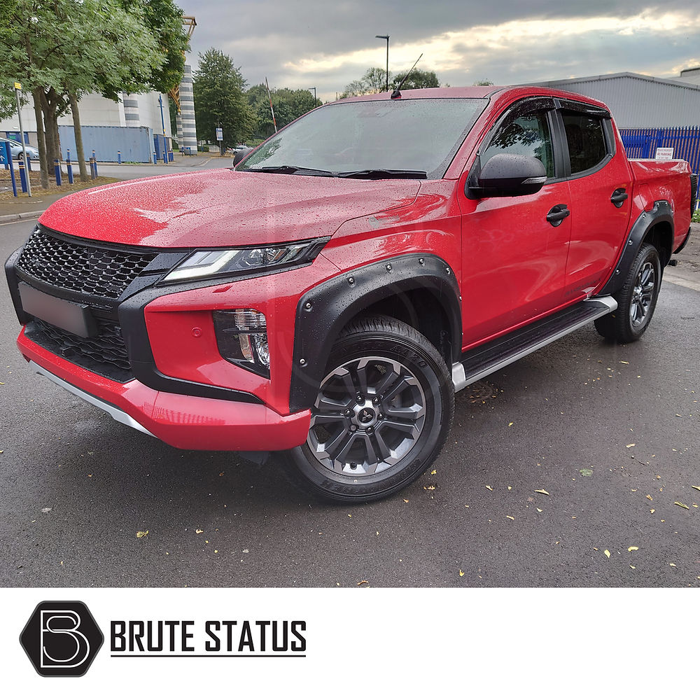 Mitsubishi L200 Series 6 2019+ Fender Flares installed on a red truck, showcasing wide arches and a smooth black finish in a parking lot.