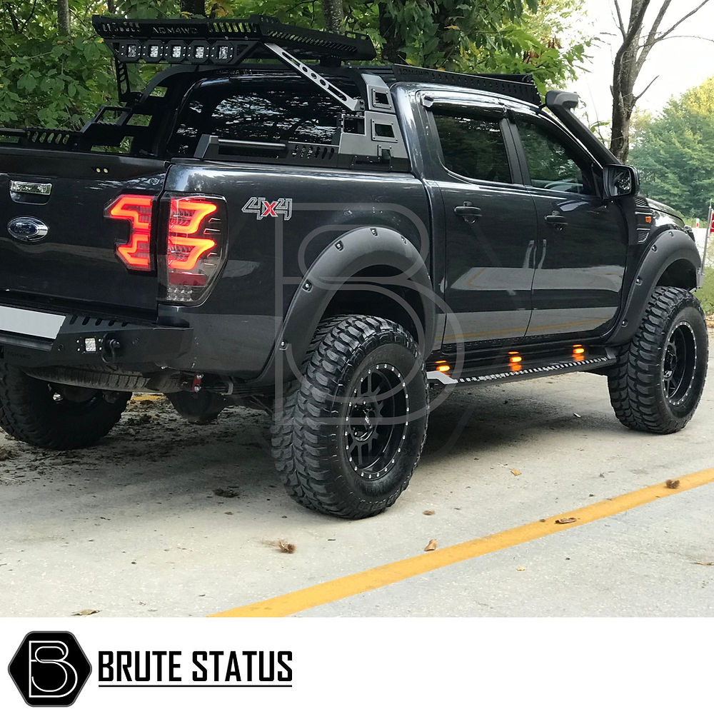 Toyota Hilux 2015+ Heavy Duty S30 Steel Side Steps with LEDs fitted on a black truck, highlighting durable design and matte black finish.