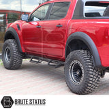 Volkswagen Amarok 2010-2022 Heavy Duty T32 Steel Side Steps, shown on a red truck, highlighting rugged tires and a sturdy, protective design.