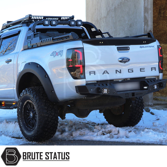 Ford Ranger 2012-2022 Combat Roll Bar with LED Lights, shown in snow, features heavy-duty steel, matt black finish, enhancing truck's aggressive look.