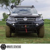 VW Amarok 2010-2016 Heavy Duty Winch Front Bumper with matte black finish and LED lights, shown on grass, ideal for off-road adventures.