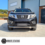 Nissan Navara NP300 2015-2022 City Bar, polished finish, enhancing vehicle look and bumper protection, visible on a black car parked in front of a building.