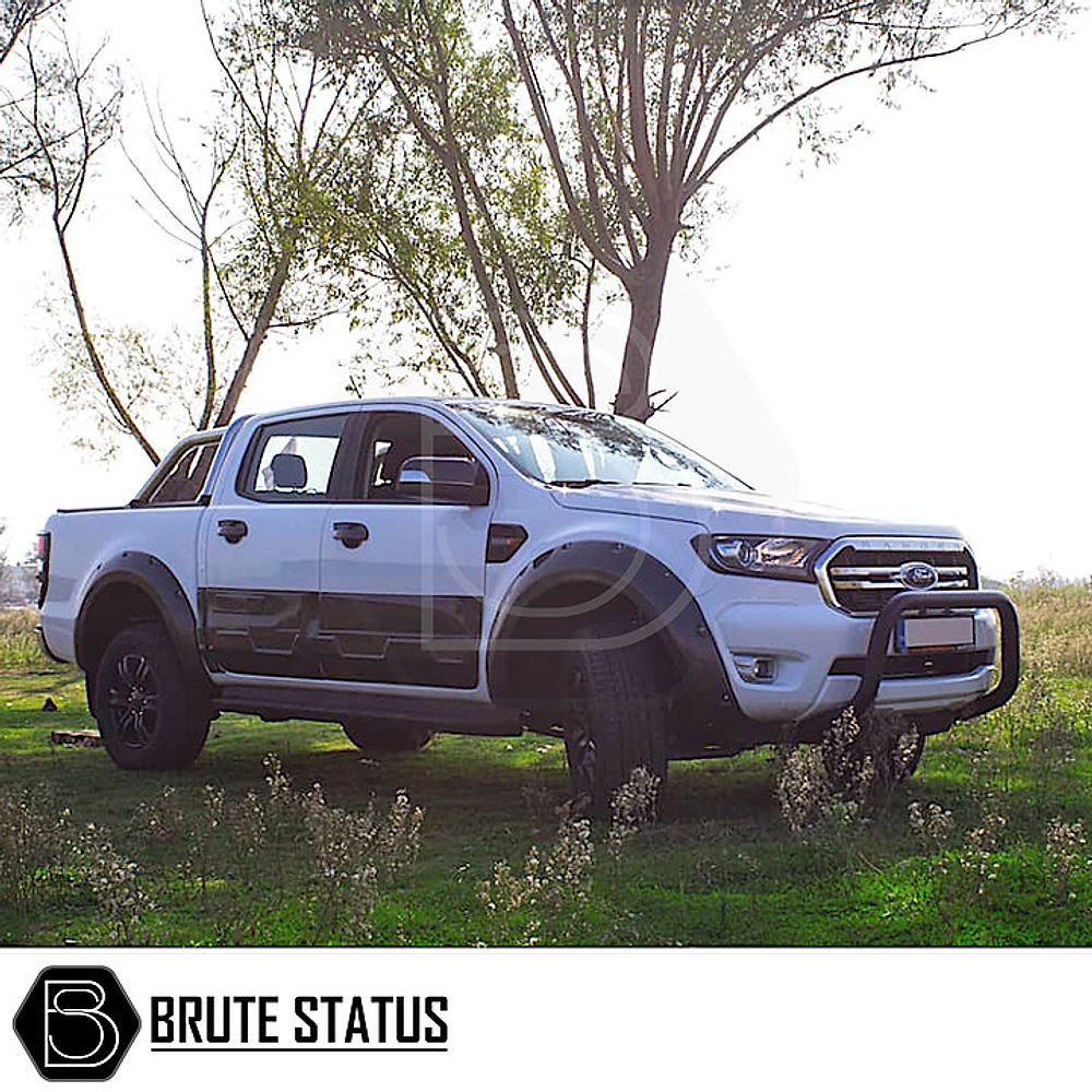 Mercedes X-Class Bull Bar (Nudge Bar) in matt black, enhancing a white truck's bumper protection, showcasing durability and easy installation in a grassy field setting.