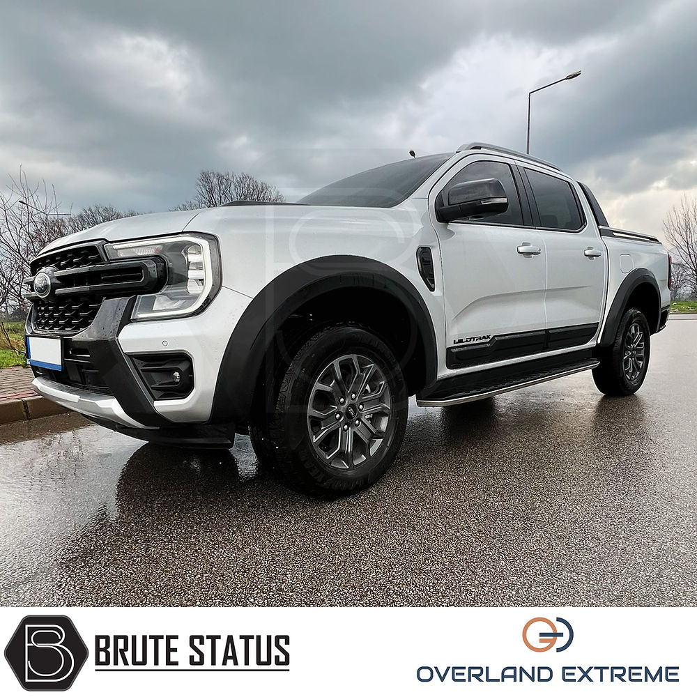 Ford Ranger 2023+ T9 Matte Black Wide Arch Kit showcased on a white truck parked on a wet road, highlighting premium wheel arches for enhanced vehicle styling.