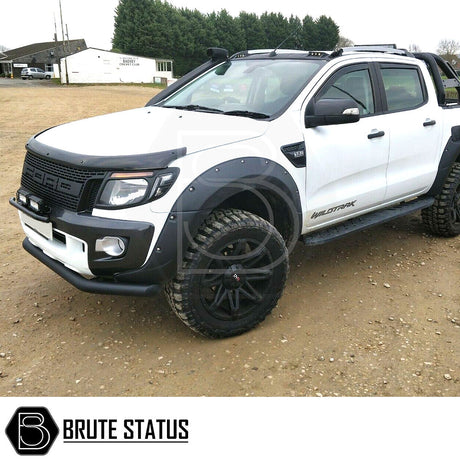 Ford Ranger 2012-15 T6 City Bar (Nudge Bar) Matt Black, shown installed on a white truck, enhancing the bumper's style and protection on a dirt road.