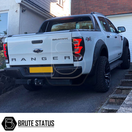 Ford Ranger 2015-19 Wide Arch Kit & 50mm Wheel Spacers - Riveted Style displayed on a white truck, showcasing robust fender flares and hubcentric wheel spacers.