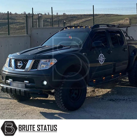 Nissan Navara D40 2006-2014 Bonnet Scoop displayed on a parked black truck, showcasing its durable ABS plastic design for enhanced vehicle customization.