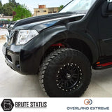 Nissan Navara D40 2005-2010 Overland Extreme Wide Arch Kit on a black truck, showcasing large tires and sleek wheel arches for enhanced vehicle style.