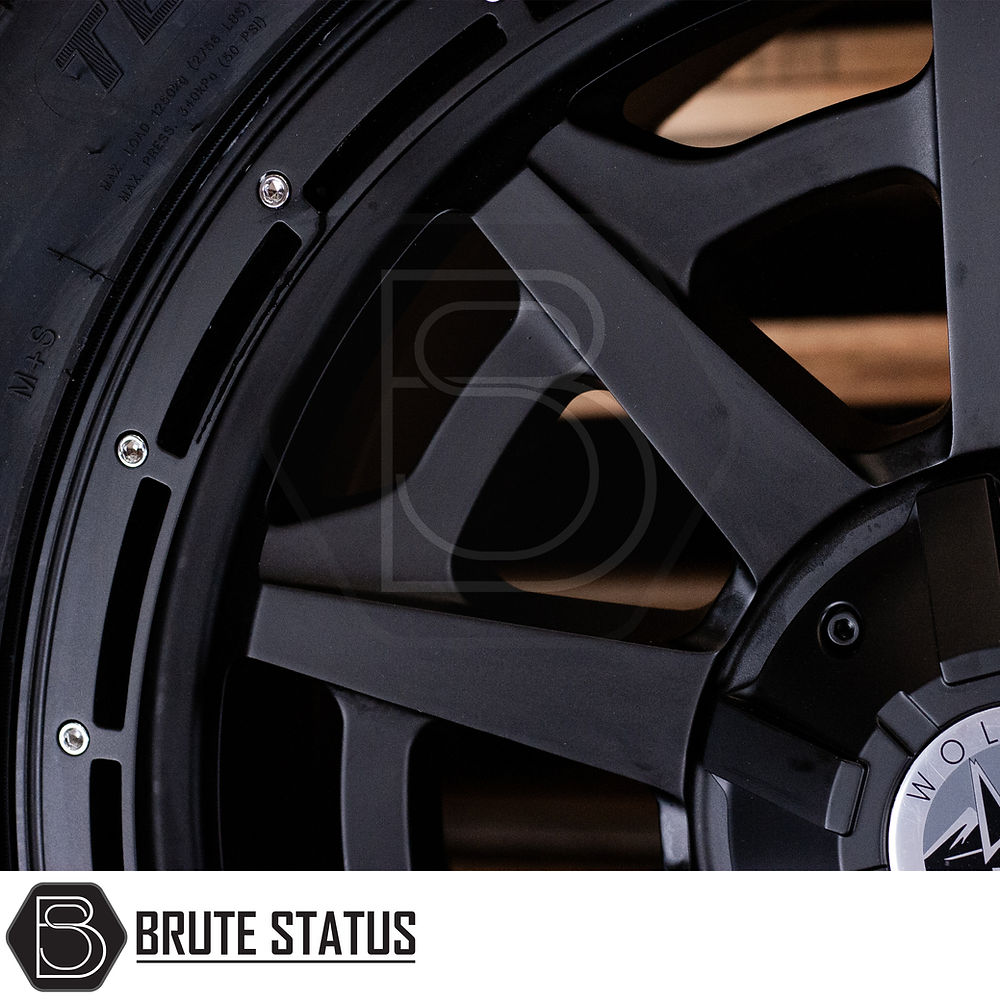 Close-up of Wolfrace Canyon Matt Black Alloy Wheels and Tyres Package, featuring chrome rivets and pre-installed TPMS, ideal for truck customization.