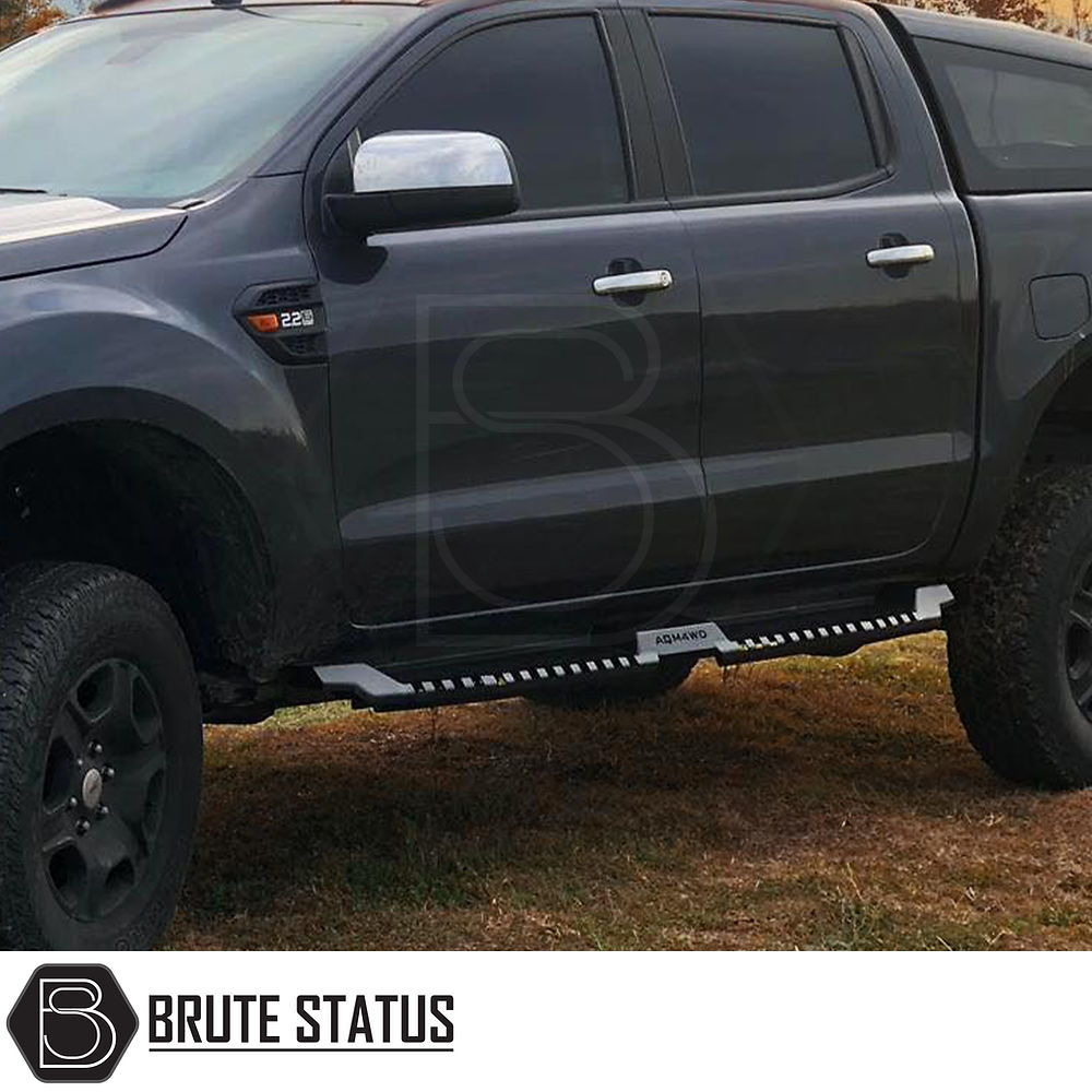 Toyota Hilux 2015+ Heavy Duty S32 Steel Side Steps, matt black, mounted on a parked truck, showcasing robust design and fitment for enhanced vehicle protection.