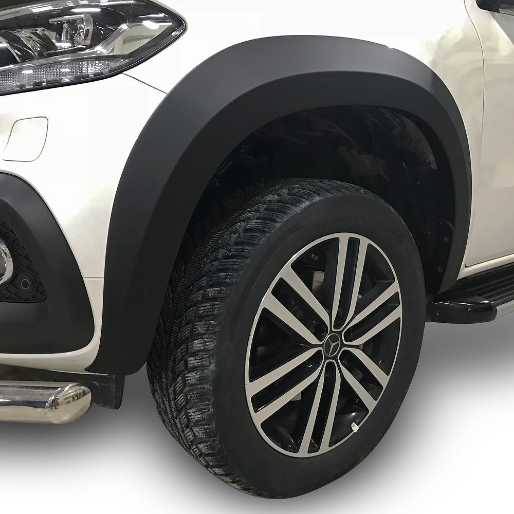 Mercedes X-Class 2017-2020 Wide Arch Kit featuring durable ABS plastic arches, close-up of the front end, headlight, and stylish tire design for enhanced truck appearance.