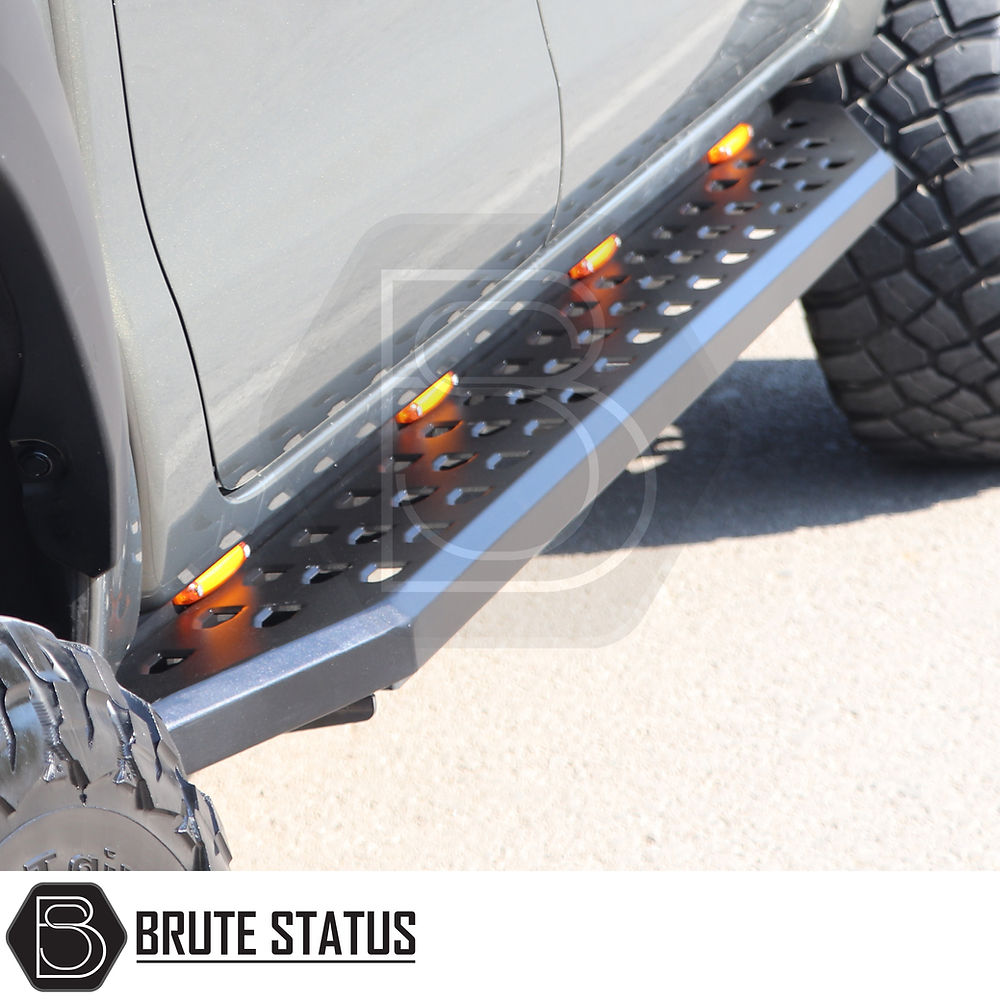 Nissan Navara NP300 2015-2022 Heavy Duty Q30 Steel Side Steps with LEDs, shown close-up, highlighting the robust steel construction and amber LED integration.