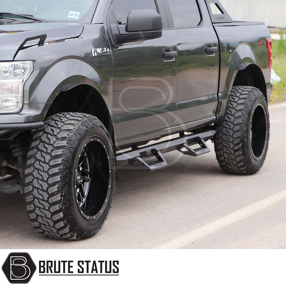 Ford Ranger 2012-2022 Heavy Duty T32 Steel Side Steps, black finish, shown with large truck tires, offering robust side protection and easy mounting.