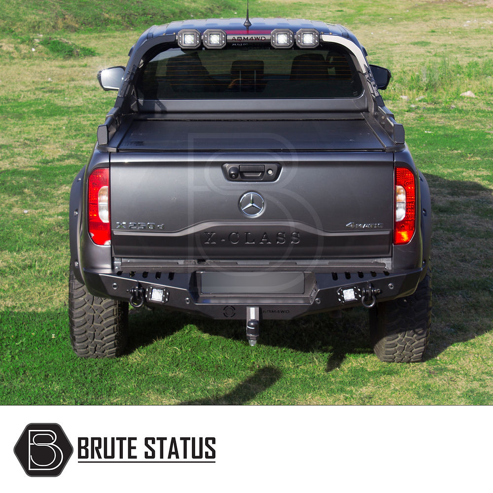 Mercedes X-Class Rear Bumper Matte Black, featuring integrated lights and sensor holes, showcased on a black truck's rear, enhancing style and protection.