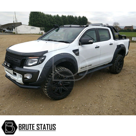 Ford Ranger 2012-15 Wide Arch Kit & 50mm Wheel Spacers seen on a dirt road, showcasing enhanced muscular look and superior stability for pickup trucks.