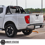 Volkswagen Amarok 2023+ Roll Bar installed on a white truck, showcasing its heavy-duty, matte black finish in a parking lot setting.