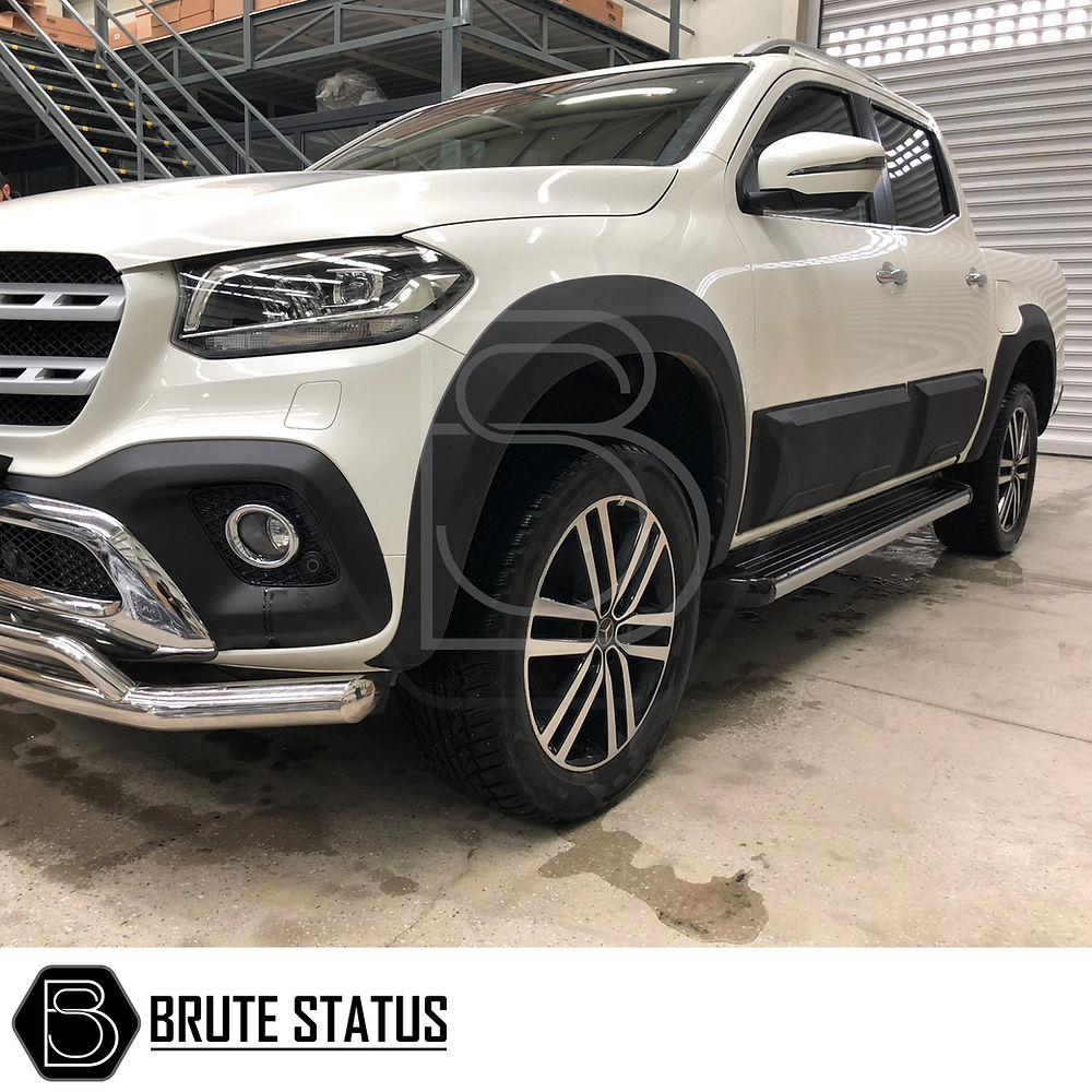 Mercedes X-Class Wide Arch Kit on a white truck in a garage, showcasing stylish, smooth black wide arches for enhanced durability and aesthetic appeal.