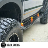 Volkswagen Amarok 2023+ Heavy Duty S30 Steel Side Steps with LEDs, close-up of tire and truck, showcasing sturdy design and matt black finish.