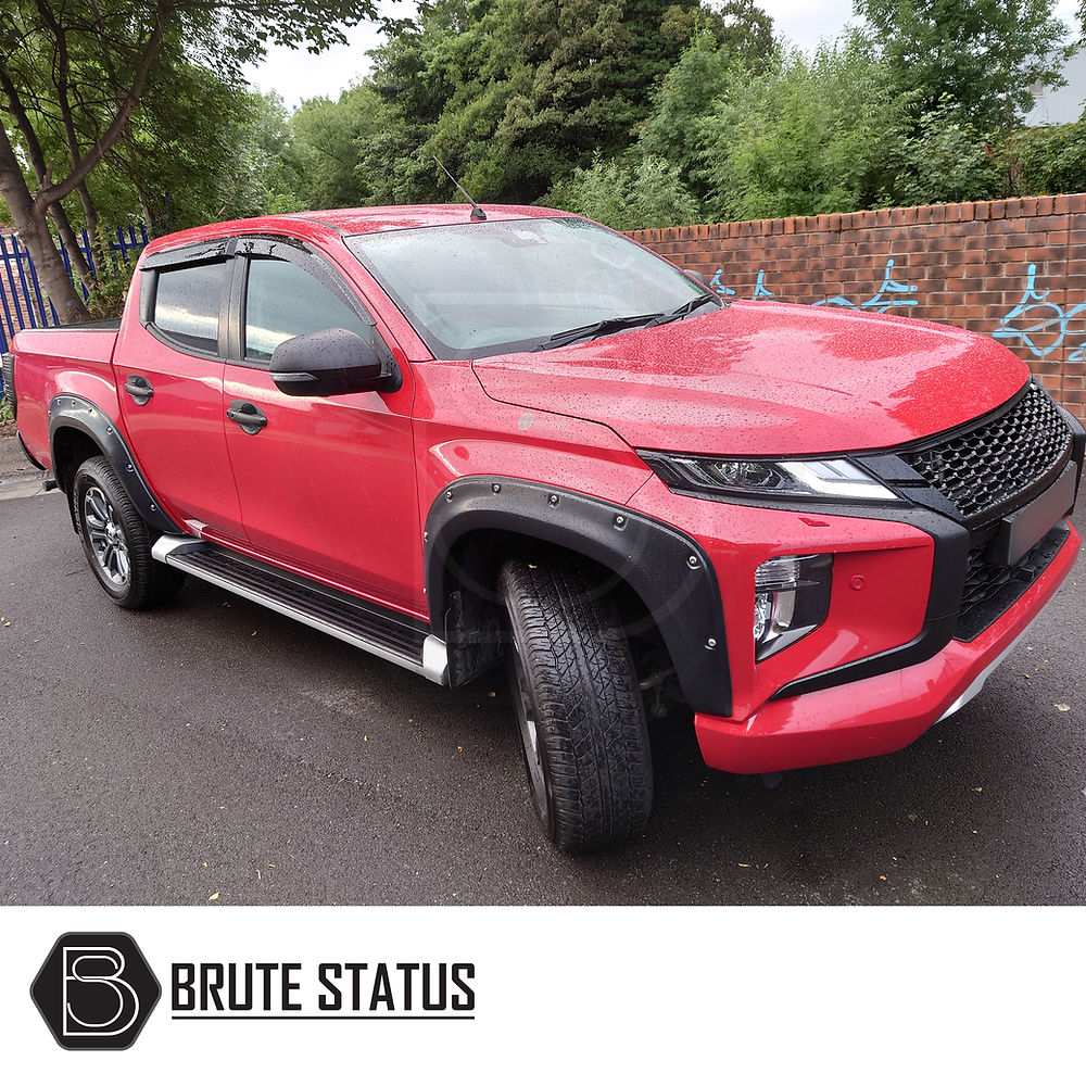 Mitsubishi L200 Series 6 2019+ Fender Flares installed on a red pickup truck, showcasing wide arches with rivet-style details and smooth black finish.