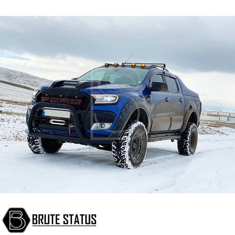 Ford Ranger 2012+ Roof Spoiler with LED Lights, visible on a blue truck in a snowy setting, showcasing its sleek design and impact-resistant material.