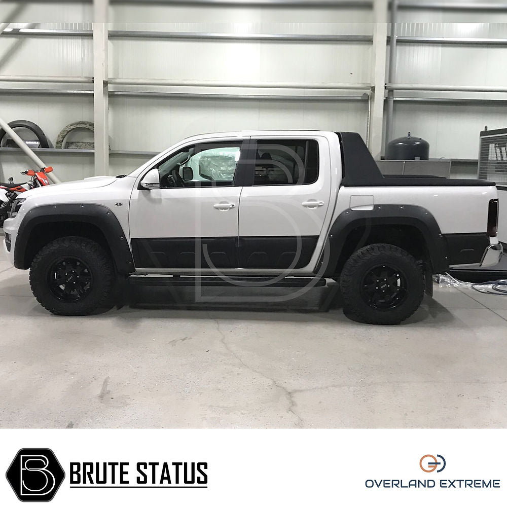 VW Amarok 2010-17 Wide Arch Kit (Overland Extreme) showcased on a white truck in a garage, highlighting premium quality and precise fitment for enhanced vehicle aesthetics.