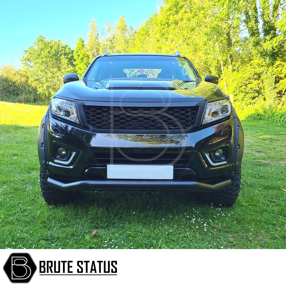 Mitsubishi L200 Series 4 2006-2014 City Bar (Nudge Bar) in matt black, enhancing truck look and bumper protection, shown on grassy outdoor setting.