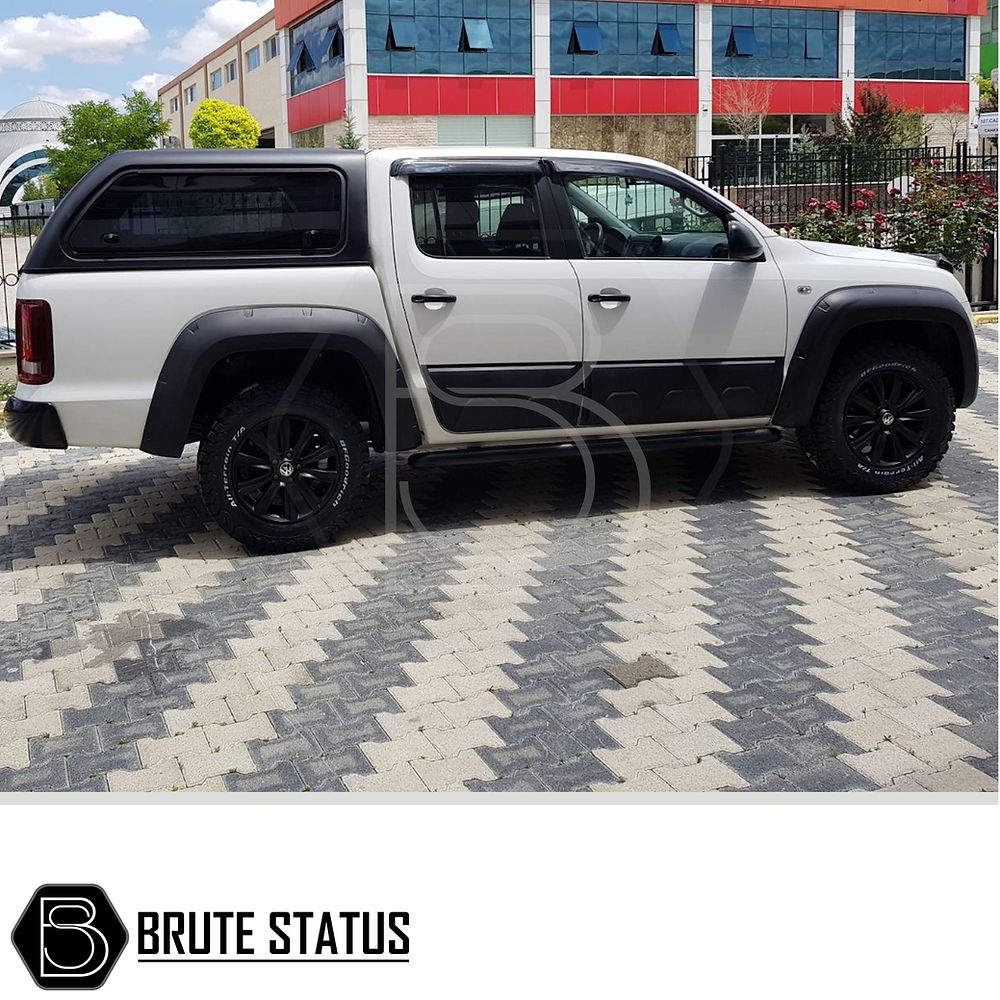 VW Amarok 2010-2022 Window Deflector Sun Shade on a white truck, showcasing its sleek, aerodynamic design and durable acrylic construction for optimal rain protection.