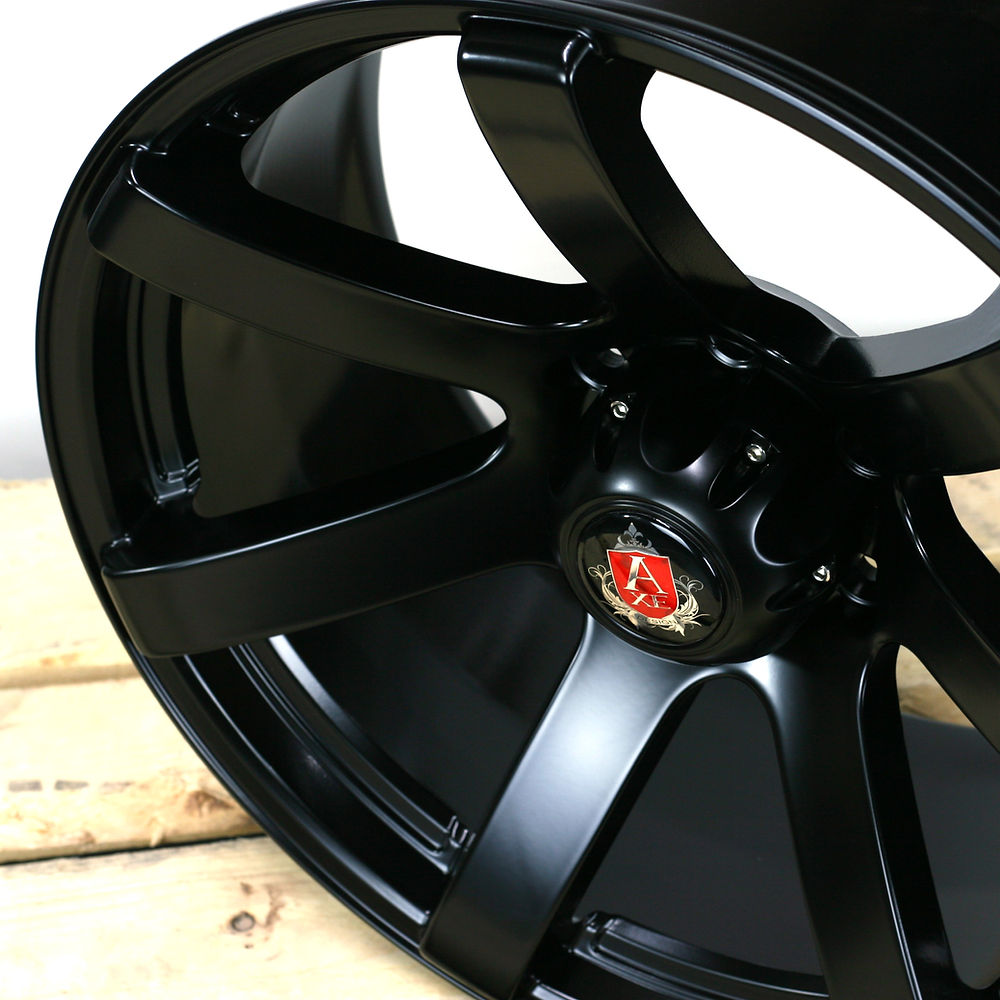 AXE Wheels Quake alloy wheel in matt black with a 6x139.7 PCD, 9x20 size, and ET10 offset, set on a wooden surface.