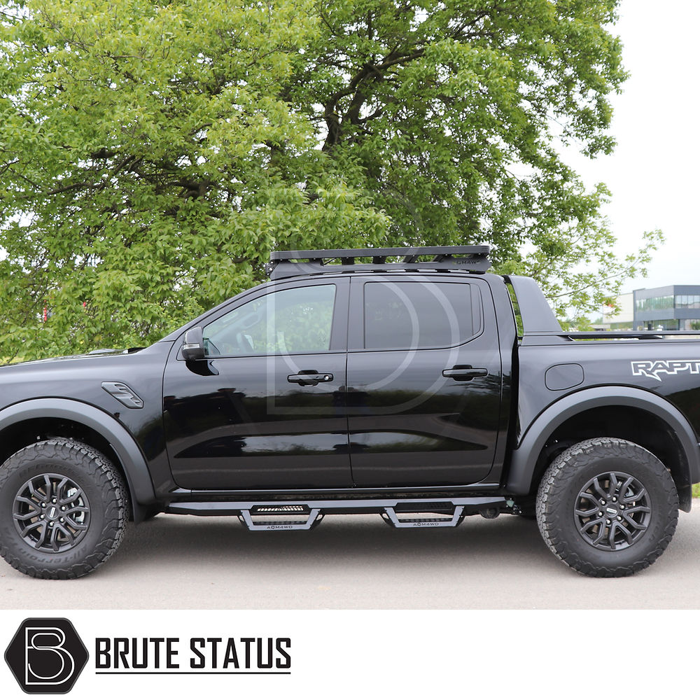 Toyota Hilux 2015+ Heavy Duty T32 Steel Side Steps in matte black, mounted on a black truck, highlighting durable, protective design for enhanced vehicle customization.