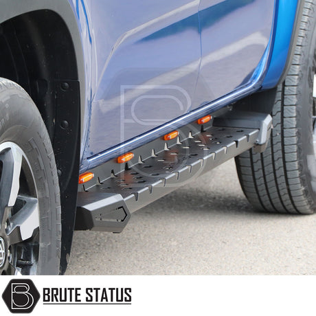 Volkswagen Amarok 2010-2017 Heavy Duty M30 Steel Side Steps, matt black finish, shown mounted on a blue truck, providing robust side protection.