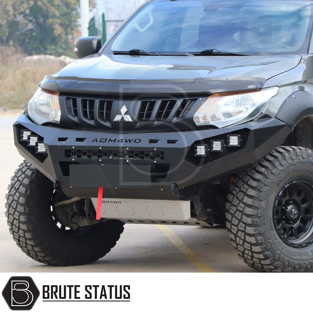 Fiat Fullback 2015-2019 Heavy Duty Winch Front Bumper with large tires, matte black finish, and bright LED lights, ideal for off-road enhancements.