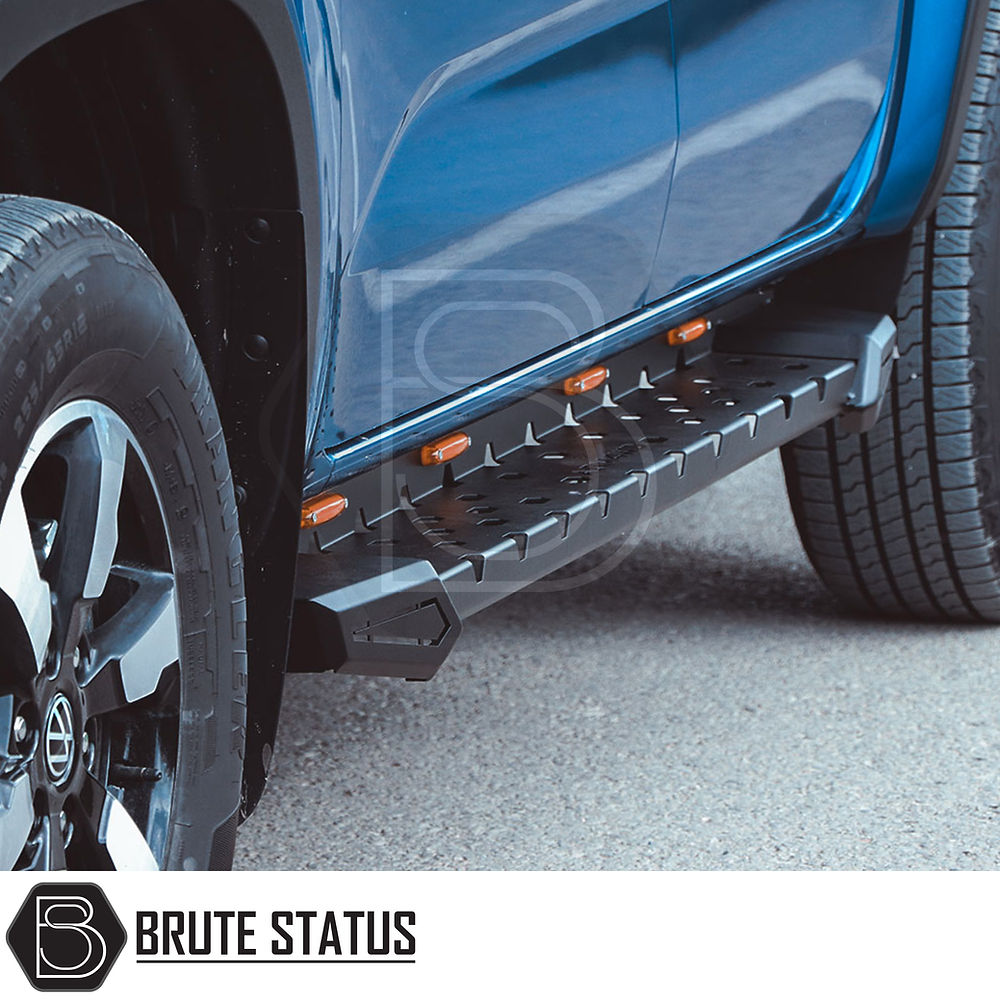 Isuzu D-Max 2021+ Heavy Duty M30 Steel Side Steps, matt black finish, shown mounted on a blue truck, highlighting tire and vehicle side details.