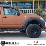 Nissan Navara D40 2010-2015 Overland Extreme Wide Arch Kit on a parked truck, showcasing premium wheel arches designed for enhanced style and durability.