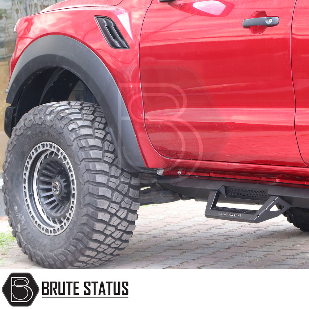 Toyota Hilux 2015+ Heavy Duty T32 Steel Side Steps in matt black, designed for durability and protection, shown close-up with mounting details visible.