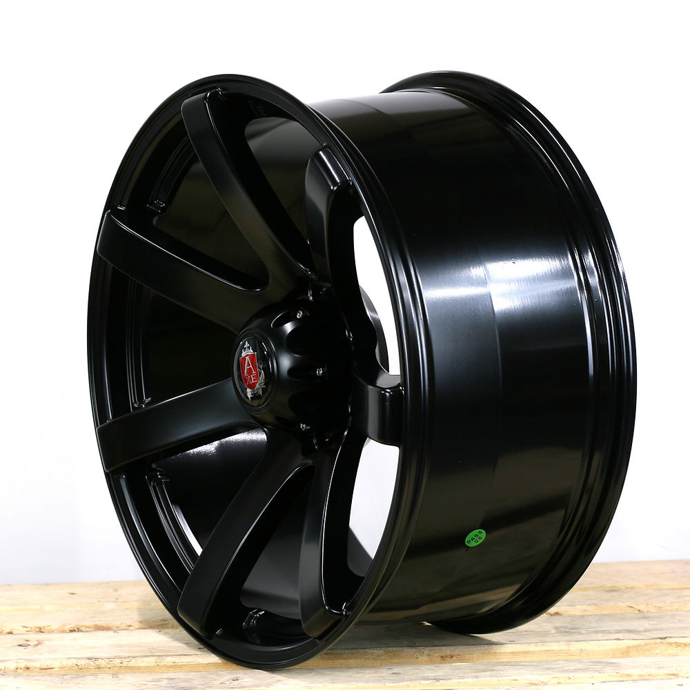 AXE Wheels Quake, a sleek black rim, features a red and silver emblem and is designed for pick-up truck customization. Set of four, 9x20 size.