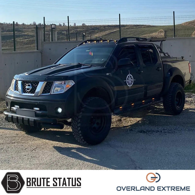 Nissan Navara D40 2005-2010 Overland Extreme Wide Arch Kit installed on a black truck, showcasing premium wheel arches in a gravel area.