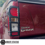 Tail Light Covers for Isuzu D-Max 2012-2019 on rear of red truck, enhancing style and individuality with a bold, aggressive look.