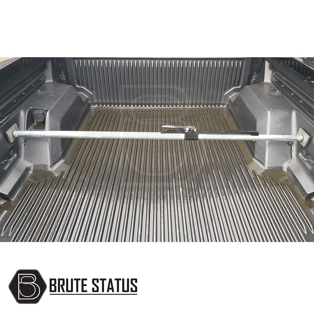 Load Bay Cargo Bar in a truck bed, featuring a central ratchet mechanism and adjustable galvanized metal for secure cargo support in pick-up trucks.