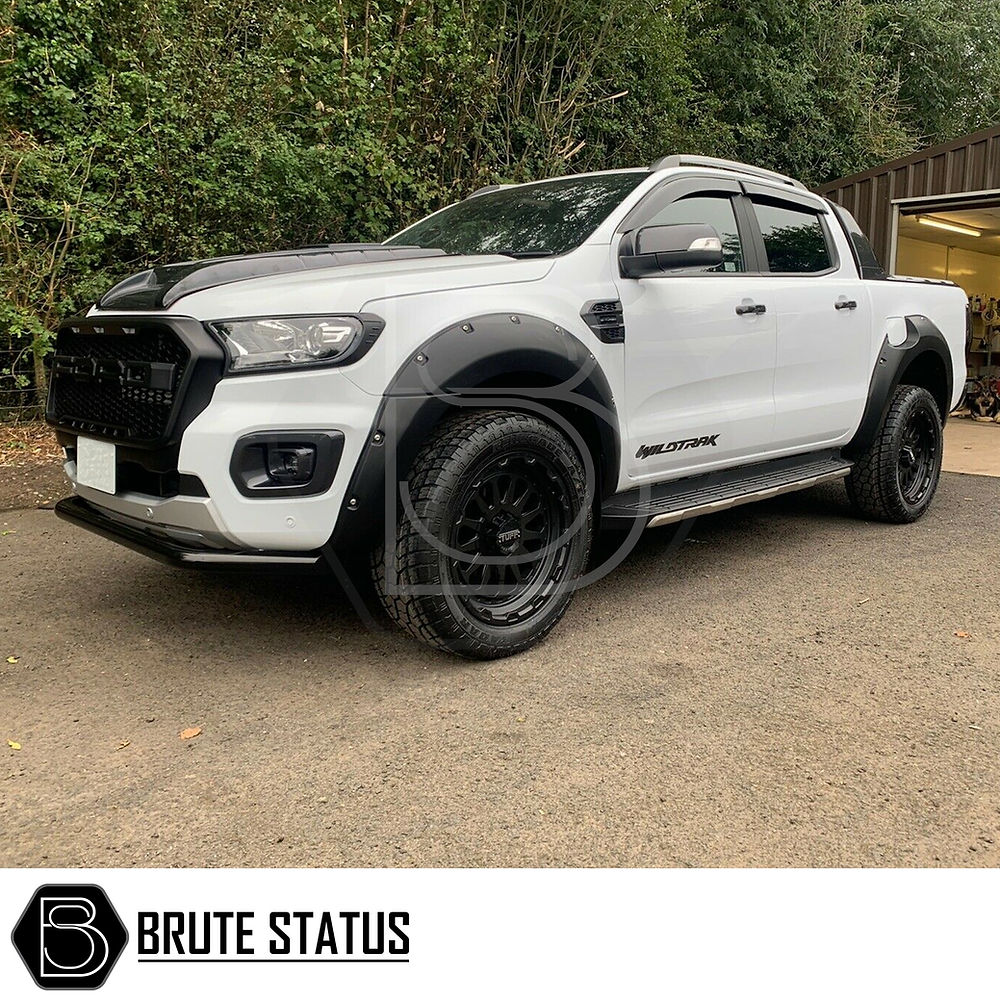 Ford Ranger 2015-2022 T7 T8 headlight and tail light covers in matte black, highlighting close-up details of the vehicle's headlight and tire.